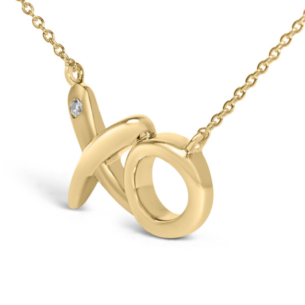 Close view of the bezel-set diamond on the 24K gold vermeil XO pendant