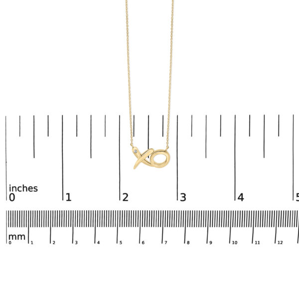 24K gold vermeil XO pendant necklace shown at scale for size reference