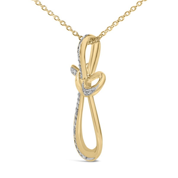 Close-up of the pave-set round diamonds on the 24K gold vermeil infinity cross pendant