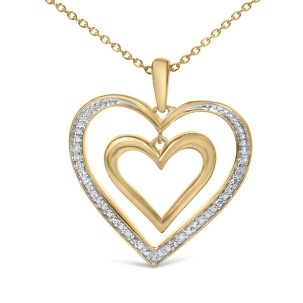 Close view of pave-set round diamonds along the edge of a 24K gold vermeil double heart pendant