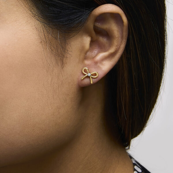 Bow earring shown worn on an ear to show placement and orientation