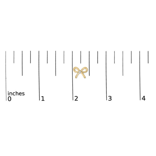 Bow earring shown next to a scale reference to indicate its small size