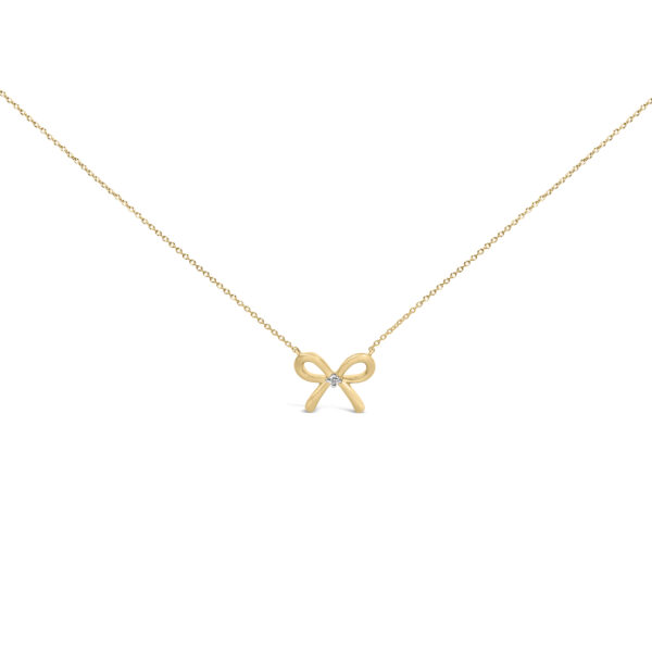 Bow tie shaped pendant in 24K yellow gold vermeil with a small prong-set diamond at its center, on a cable chain