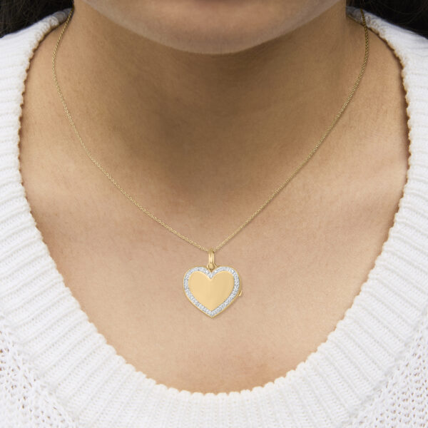 Heart locket pendant necklace shown worn at the neckline