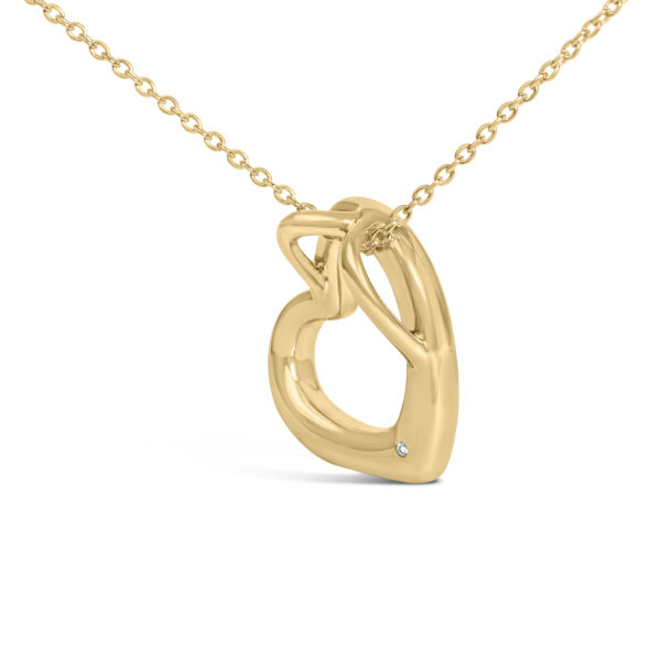 Heart pendant and cable chain laid out to show the full necklace length