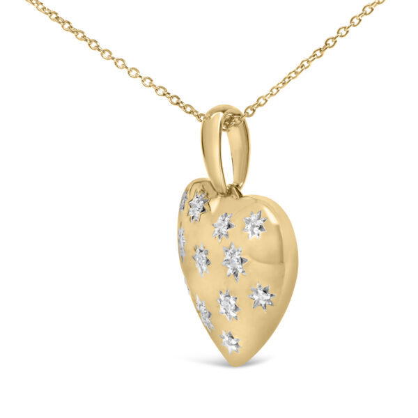 Close-up of round diamonds prong-set into a 24K gold vermeil heart pendant