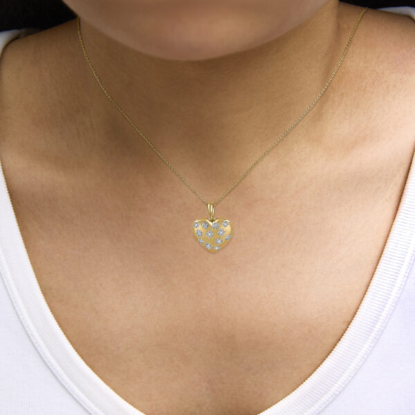 24K gold vermeil heart pendant necklace worn at the neckline on a model