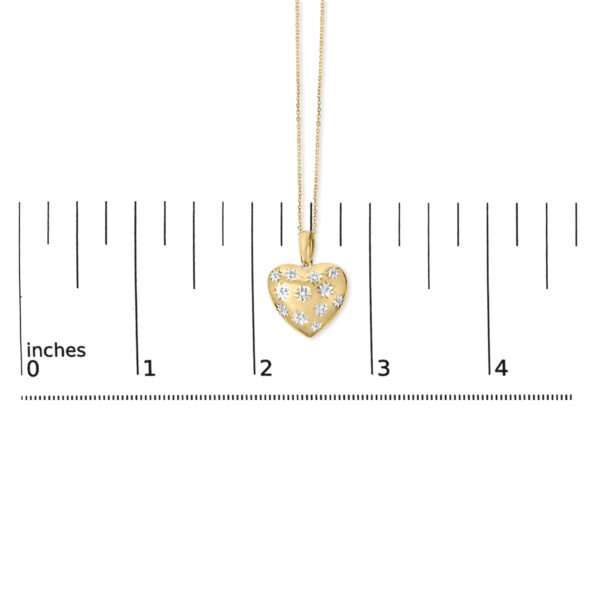 24K gold vermeil heart pendant and chain laid flat next to a scale reference showing overall size