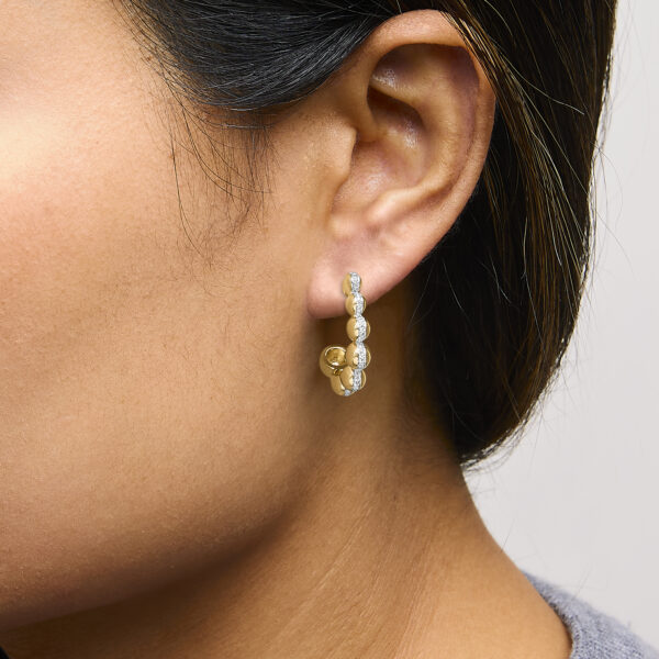 24K gold vermeil diamond earring worn on an ear