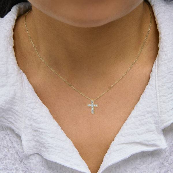 Cross pendant necklace displayed as worn on a neck to show drape and chain length