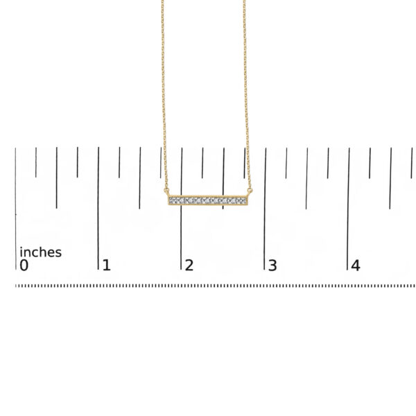 Bar pendant necklace shown against a scale reference for size
