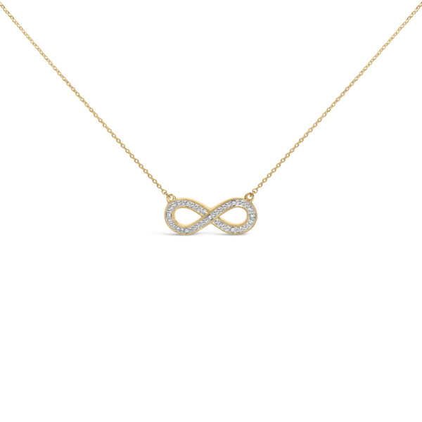 Infinity-shaped pendant with pavé-set round diamonds on a cable chain, laid flat against a plain background