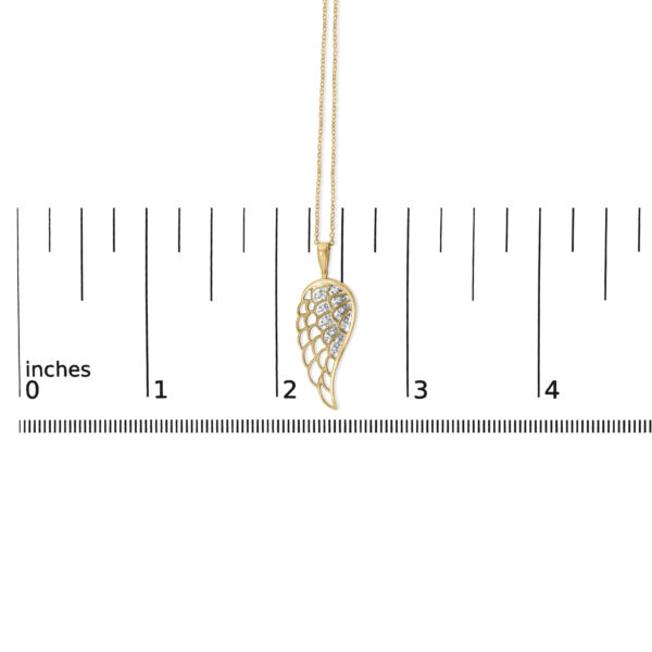 Angel wing pendant necklace laid out to show scale against a reference object