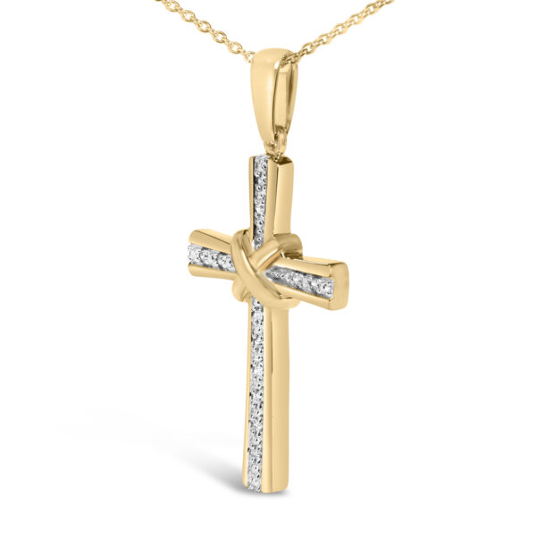 Close-up of the cross pendant showing individual round diamonds set in pave setting