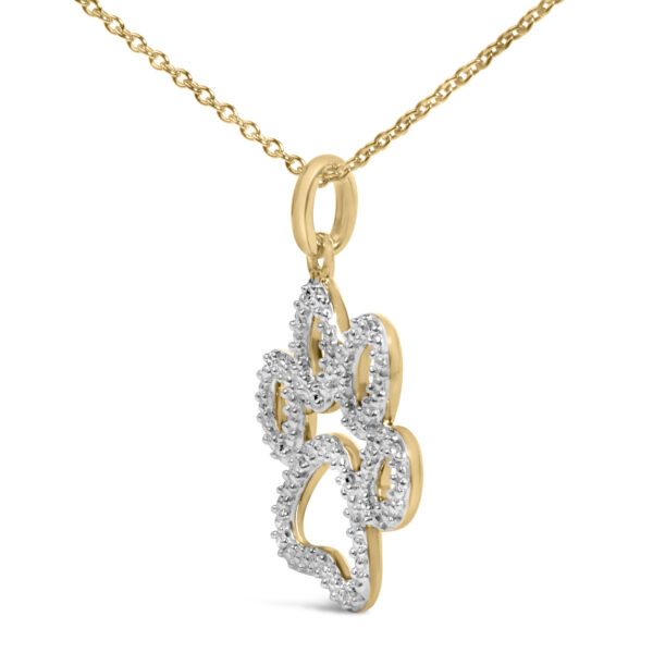 Close-up of the paw pendant highlighting the round diamonds set into the gold-tone metal