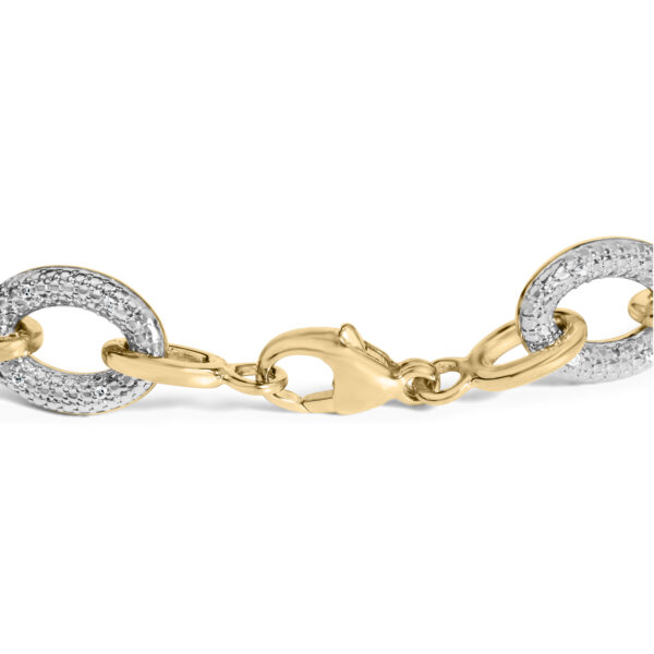 Close angle of the bracelet showing pave-set round diamonds within the oval links