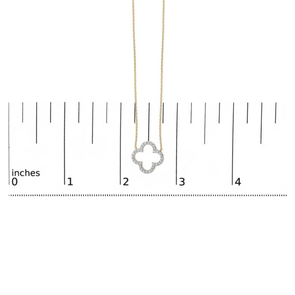24K gold vermeil clover pendant shown against a scale reference to indicate its size