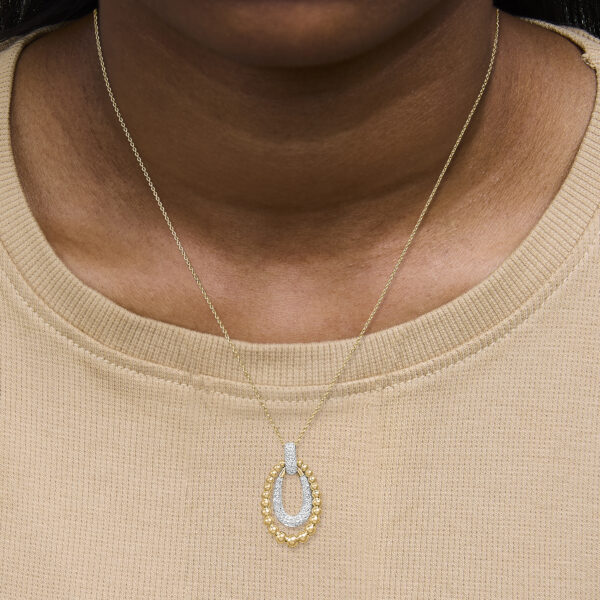 Gold vermeil bead pendant necklace worn on a model's neckline