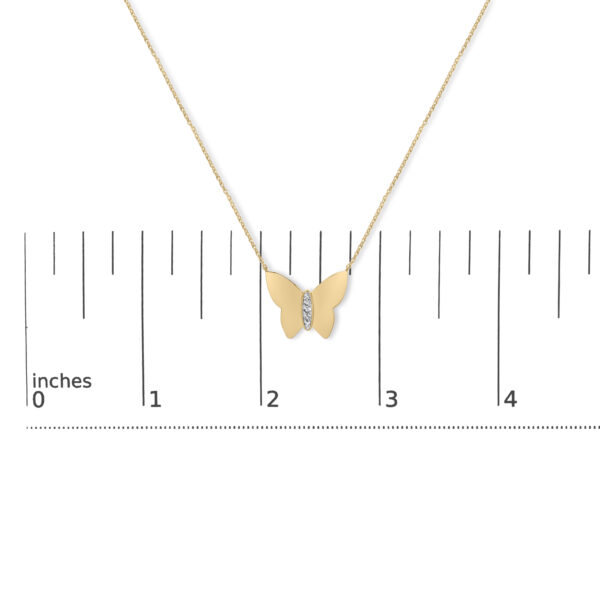 Butterfly pendant necklace shown next to a scale reference for size comparison