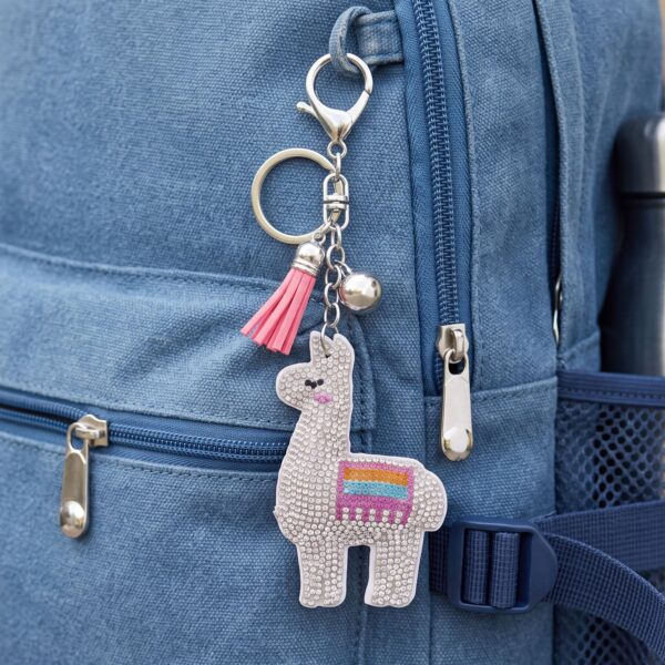 Alternate angle of the silver tone crystal llama bag charm showing the tassel and bell detail