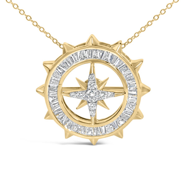 Close-up of the compass medallion pendant showing the channel-set baguette diamonds and center round diamonds